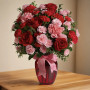 Dance with Me Bouquet featuring red roses and pink carnations arranged in a red glass vase with ribbon, romantic flower arrangement by local florist