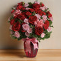 Dance with Me Bouquet featuring red roses and pink carnations arranged in a red glass vase with ribbon, romantic flower arrangement by local florist