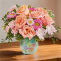 Pastel flowers in a cute vase with a floral design
