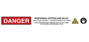 An image of a roll of barricade tape.  DANGER is written in white letters on a red background.  Respirable Crystalline Silica. is written in bold capitals letters.  "May Cause Cancer. Causes damage to Lungs. Wear Respiratory Protection in this Area. Authorized Personnel Only" is written in smaller capital letters.  The text is punctuated by two images; A skull and cross bones graphic for toxicity and a respirator graphic to emphasize required respiratory protection.
