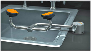 A photograph of a Guardian G1774 Eyewash with right-hand mounting installed to the right of an existing sink (sink and counter are not included).