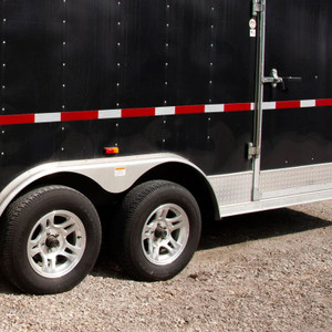 A picture of red and white Conspicuity DOT-C2 Reflective Tape deployed on the side of a trailer.