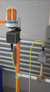 A photograph of an AP275-700N4 Series Electric Alarm Unit w/ Strobe Light and Horn for NEMA 4 Environments installed on a safety shower.