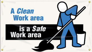 Picture of Workplace Safety Banner that features a professional white background, and wording "A clean work area" in bold blue text. Continued just below it in clean white text on a black stripe is "is a safe work area". On the right side of the poster is a worker in blue clothes with a mop.