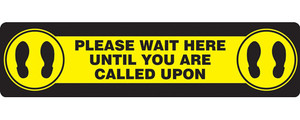 A photograph of a yellow and black 11201 social distance floor sign, reading please wait here until you are called upon, with dimensions 6" x 24", and footprint icons.