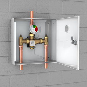 A photo of the G6021 TMV in a surface-mounted cabinet installed on a cinderblock wall.