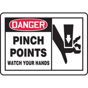 A photograph of a 01763 Danger Pinch Points Watch Your Hands OSHA-style Sign w/ Graphics.  The left side of the sign has the word DANGER! in white lettering on a red background with the words "Pinch points.  Watch your hands" in black lettering on a white background directly below.  The right side of the sign has a black graphic of  a hand being pinched, on a white background.