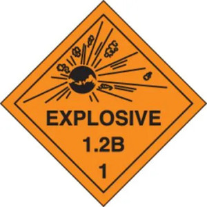 An orange and black photograph of a 03063 dot explosives shipping label, reading explosives 1.2B 1 with graphic.