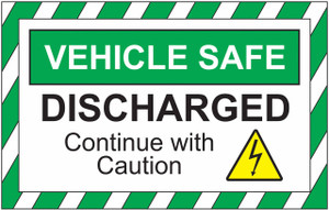 Image of the green and white high visibility sign featuring the text: "VEHICLE SAFE DISCHARGED - CONTINUE WITH CAUTION", with a yellow electrical discharge symbol, facing straight ahead.