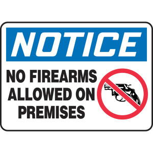 A photograph of An OSHA No Firearms Sign.  The word "NOTICE" is in white letters on a blue background at the top of the sign.  Below the header are the words "No Firearms Allowed on Premises" in black on a white background next to a graphic of a pistol with a red circle with a line through it.
