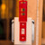 A photograph of a red 07156 zing recyclockout™ wall light switch lockout device installed on light switch in open position.