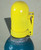 A photograph of back of a yellow 07200 justrite safety snap cap heavy-duty gas cylinder lockout device with padlock in closed position.