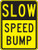 A photograph of a black and yellow 06250 speed bump sign, reading slow speed bump.