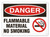 A photograph of a 01562 danger, flammable material no smoking OSHA sign with no smoking icon.