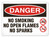A photograph of a 01564 danger, no smoking no open flames no sparks OSHA sign with no smoking and no flame icons.
