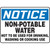 A photograph of An OSHA Non-Potable Water Sign.  The word "NOTICE" is in white letters on a blue background at the top of the sign.  "Non-Potable Water, Not to be Used for Drinking, Washing or Cooking Use" printed in black letters on a white background below.