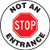 This white and black sign reads "Not An Entrance" around the edge. The center features a large red stop sign that says "STOP". Use this to mark roadways as one-way exits only.