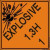 An orange and black photograph of a 03064 dot explosives shipping label, reading explosives 1.3H 1 with graphic.