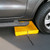A photograph of an unfolded 5 gallon capacity Justrite Folding Utility Tray, under wheel well of a car.
