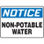 A photograph of a Non-Potable Water Sign.  The word "NOTICE" is in white letter on blue across the top.  The words "NON-POTABE WATER" are in black on a white background below.