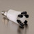 A photograph of a  PTFE manifold with a stainless steel stacker connector.
