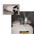 A photograph of a PTFE manifold with a polypropylene fitting and a photograph of  it attached to a Justrite HPLC Safety Can and attached to four intake tubes.