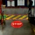 Image showing the "STOP" and "YIELD TO PEDESTRIAN" symbols being projected onto a facility floor.