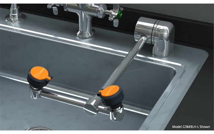 A photograph of a Guardian G1849LH-L eyewash mounted on the counter behind a sink (sink not included).