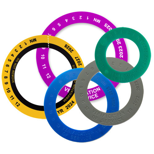 A photograph showing one each of the, gray, blue, green, yellow/black and violet 09780 verification of service collars.