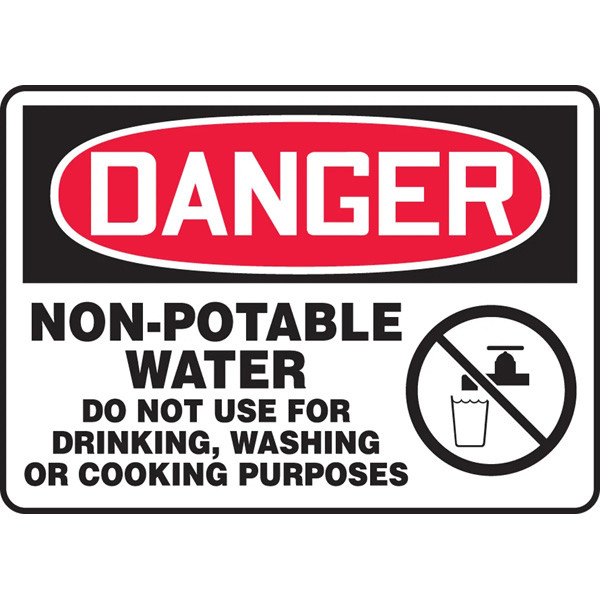 A photograph of an OSHA non-potable water sign.  It features an OSHA DANGER header at the top - the word danger in white lettering on a red oval contained with a a black background.  Below the header are the words "Non-Potable Water Do Not Use for  Drinking Washing or Cooking Purposes" in black on a white background.  To the right of the text is a graphic of a glass full of water underneath a tap, all within a circle with a line through it.