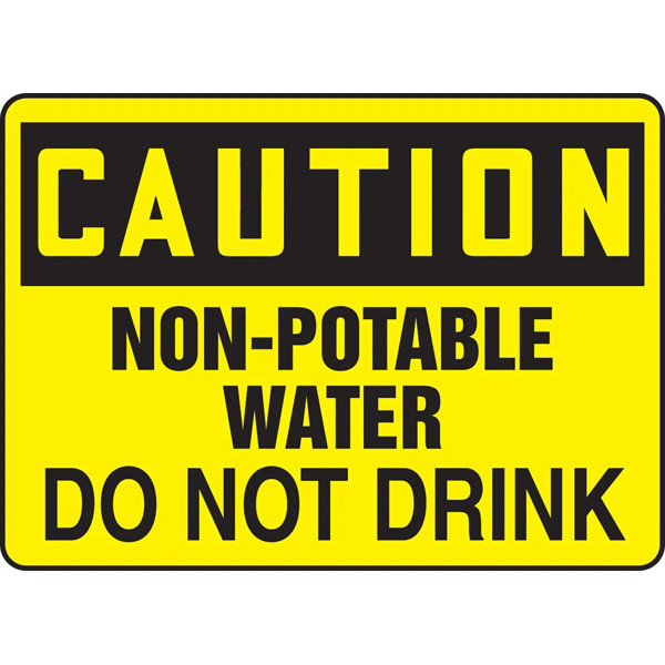 A photograph of An OSHA Non-Potable Water Sign.  The word "CAUTION is in yellow letters on a black background at the top of the sign.  The words "Non-Potable Water, Do Not Drink" are printed in black letters on a yellow background below the header.