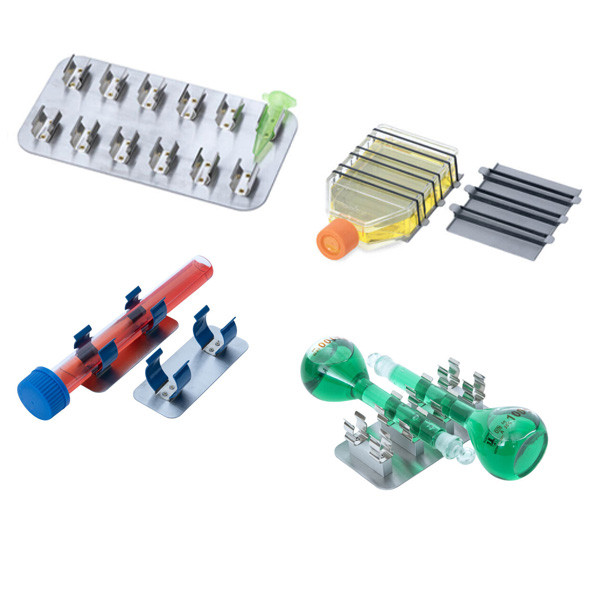 A photograph of several types of Clip-Plates:  Universal Clips Plate, Hybridization Tube Clip Plate,  Multi-Tube Clip Plate, 100 ml Volumetric Flask Cli plate.