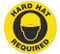 A photograph of an anti-slip safety floor markers, reading hard hat required.