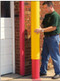 Photograph of eagle smooth bollard post sleeve being installed on a post.