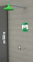 A photograph of a green Guardian GFR1205GRN Freeze-Resistant Emergency Shower installed in a cinderblock wall.