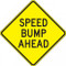 A photograph of a yellow and black 06256 speed bump sign, reading speed bump ahead.