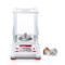 Photograph of Ohaus Adventurer™ Semi-Micro Balance with draft shield closed, front facing, with calibration weights (not included).