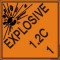 An orange and black photograph of a 03063 dot explosives shipping label, reading explosives 1.2C 1 with graphic.
