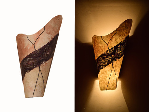 Day and night view of the same wall light.  Nomex, the diffuser shown here, is flexible, water resistant, fire resistant and translucent.