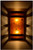 Dark antique copper banded wall light with amber mica at night
