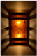 Dark antique copper banded wall light with amber mica at night