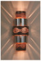 Burned copper and stainless steel wall sconce shown at night.