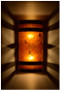 Dark antique copper banded wall light with amber mica at night