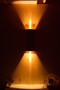 Cylindrical sconce shown with GU10 bulbs.  These bulbs are much more intense and directional than standard medium base LED or incandescent bulbs thus they will shine further up and down your wall or column.