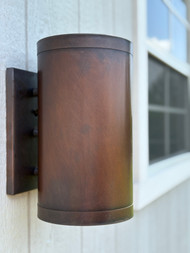 This beautiful Full Cylinder sconce is out of the showroom. There is only this one. It has a dark antique finish. "As is" but is fully functionable and ready to install!