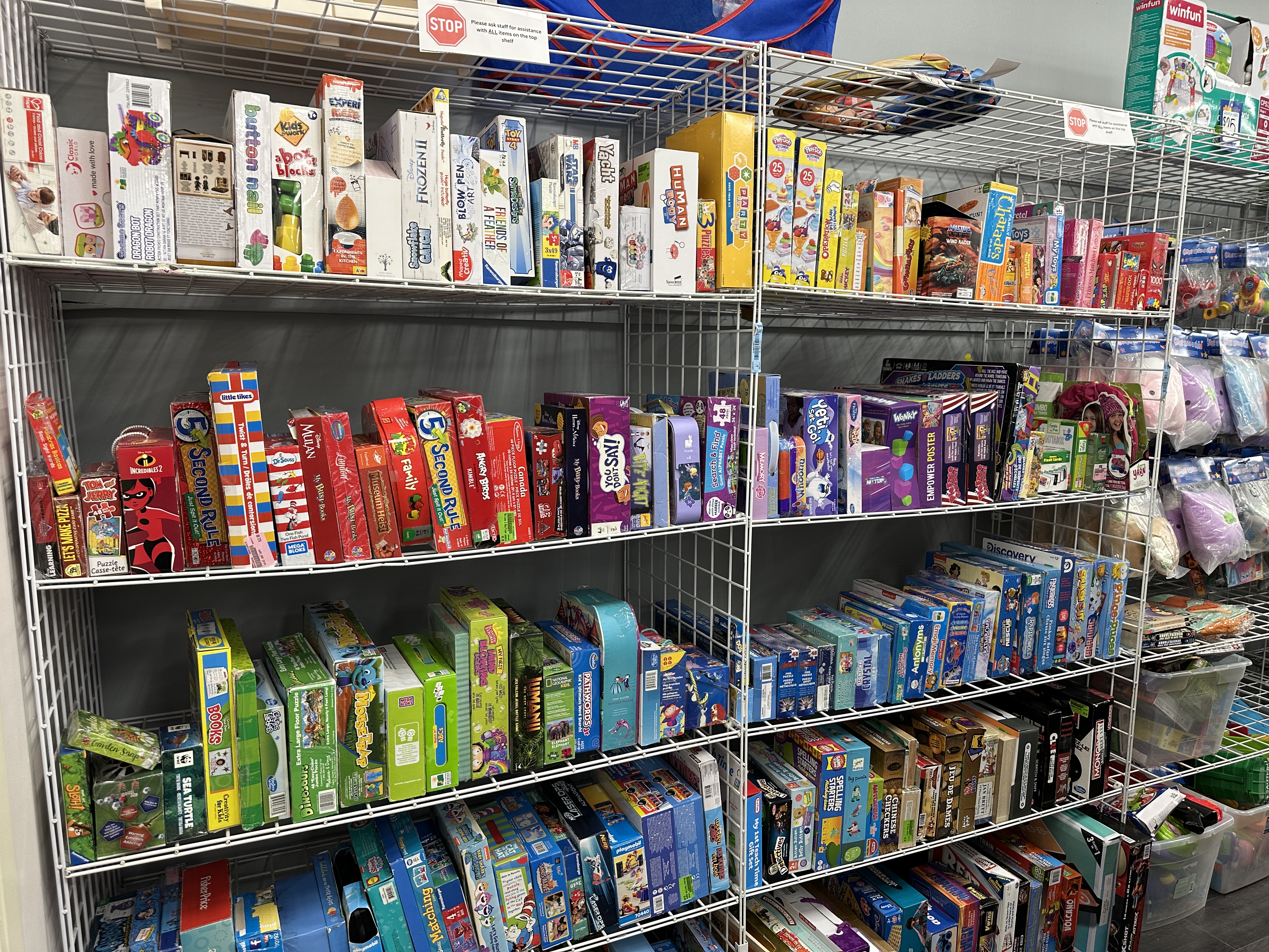 Interior photo showing shelves full of children's games and toys