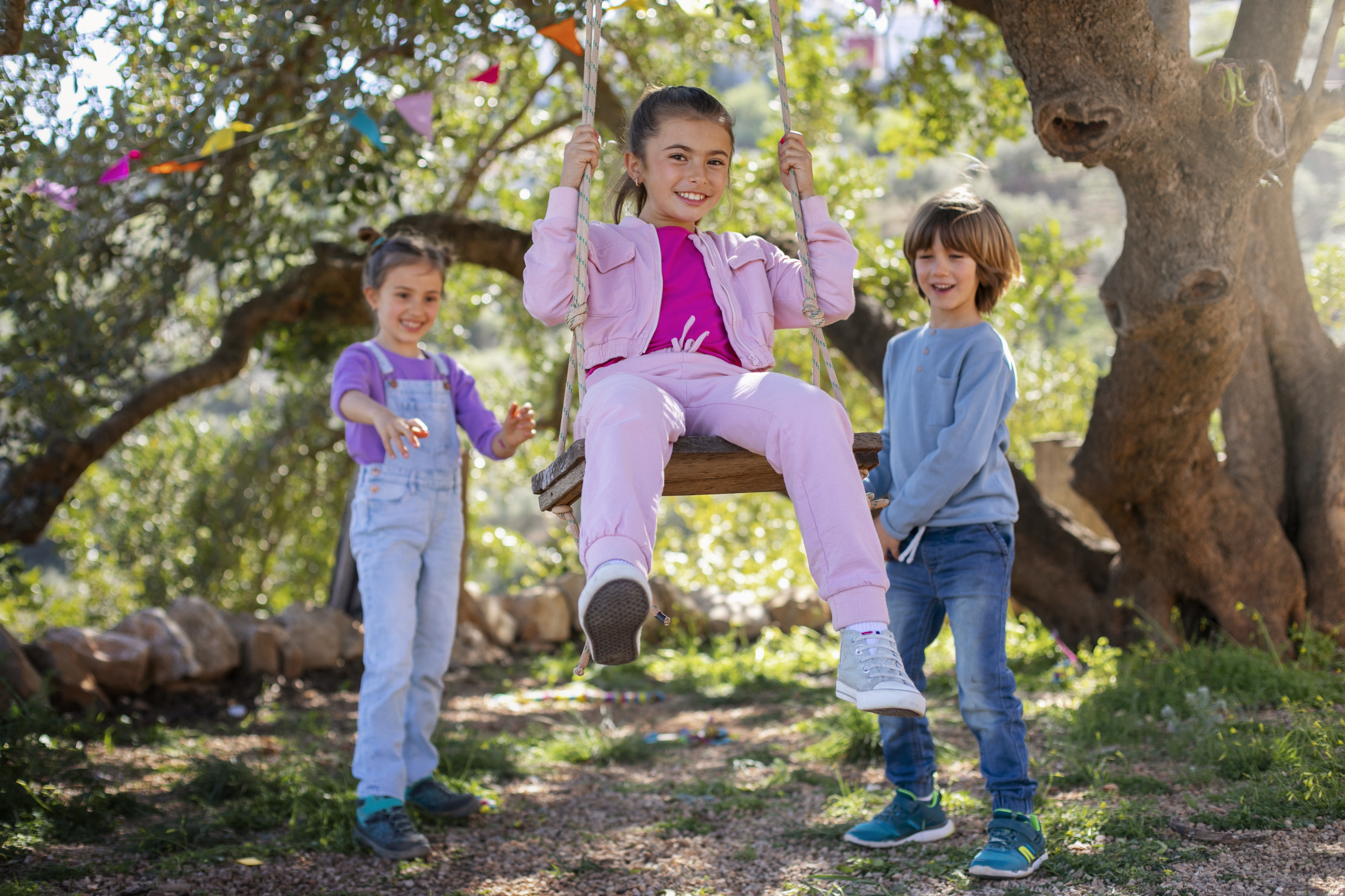 Portrait of a cheerful brother and sister sitting at home on christmas and new year's eve, embracing and smiling at the camera.