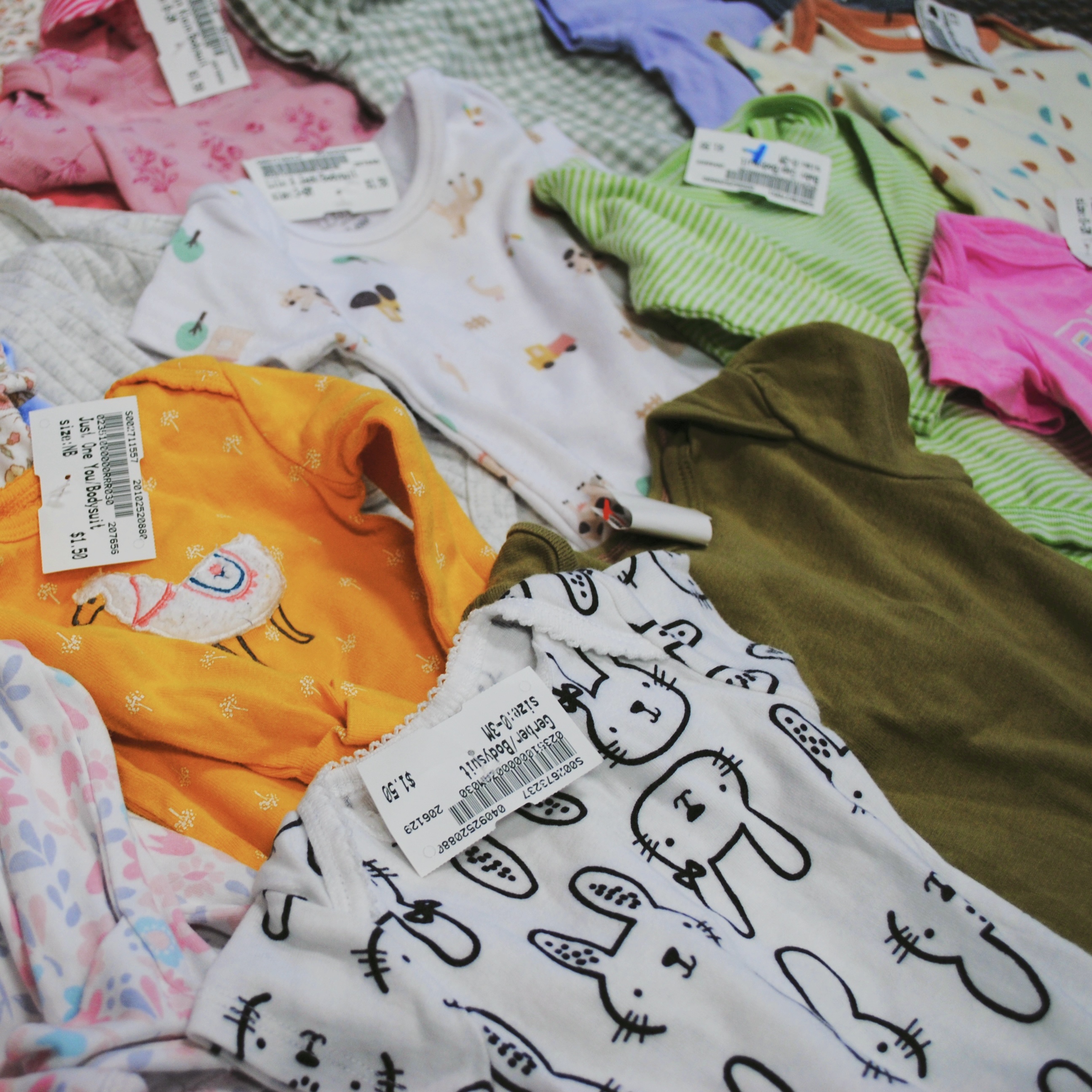 Baby onesies on the floor