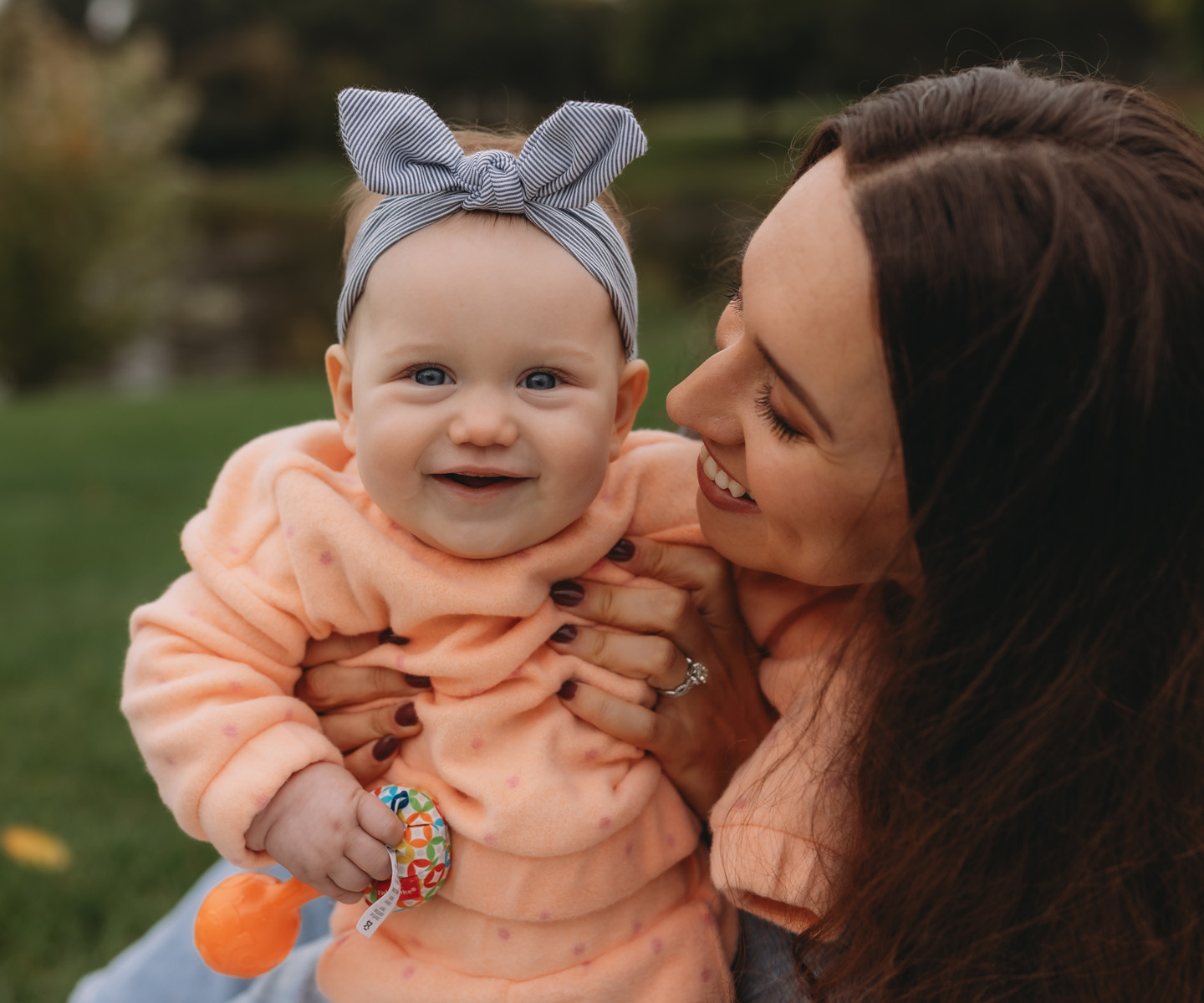 A Mom and baby smiling