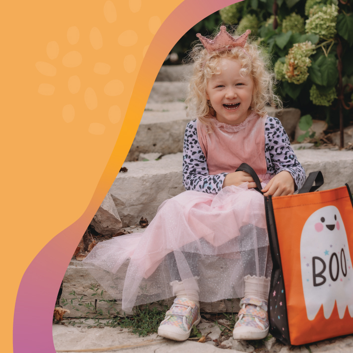 little girl in halloween costume smiling